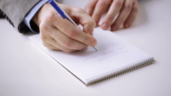 Close Up Of Businessman Hand Writing To Notepad 2