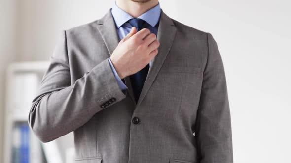 Close Up Of Man In Suit Fastening Button On Jacket 1