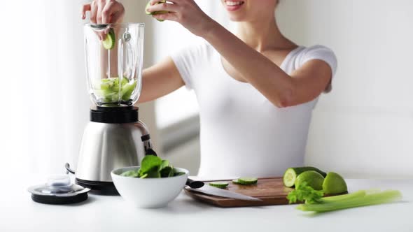 Smiling Woman With Blender And Green Vegetables 1
