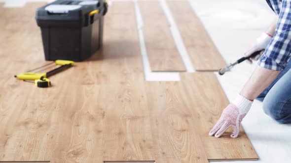 Close Up Of Man Installing Wood Flooring 1