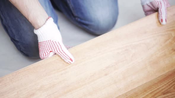 Close Up Of Man Installing Wood Flooring 10 alt