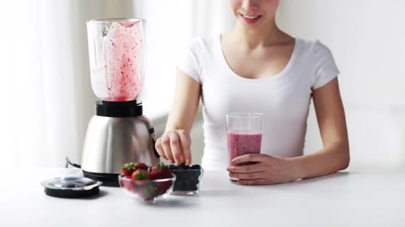 Smiling Woman With Blender Jar Pouring Milk Shake