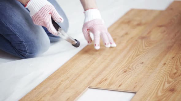 Close Up Of Man Installing Wood Flooring 12 alt