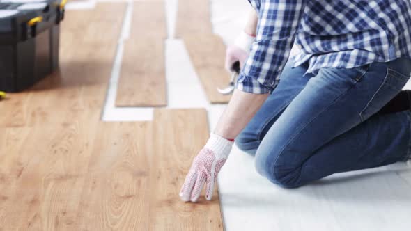 Close Up Of Man Installing Wood Flooring 2