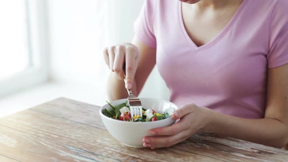 Close Up Of Young Woman Eating Salad At Home 1
