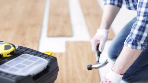 Close Up Of Man Installing Wood Flooring 3 alt