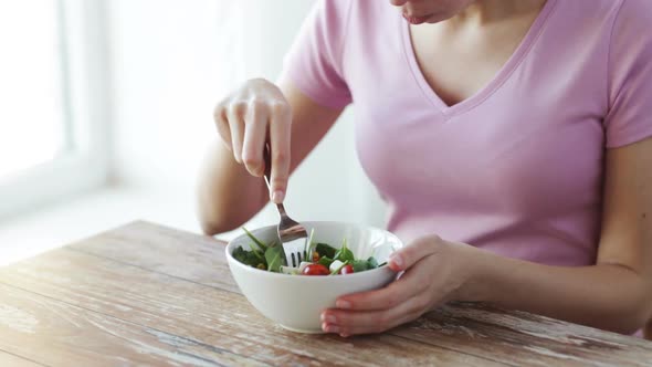 Close Up Of Young Woman Eating Salad At Home 2