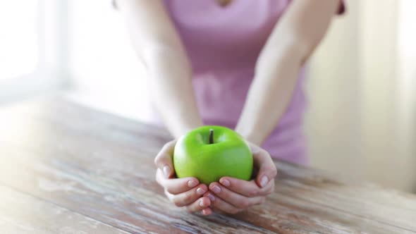 Close Up Of Young Woman Hands Showing Green Apple 1