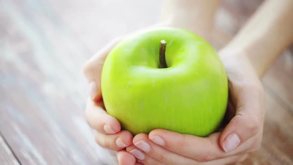 Close Up Of Young Woman Hands Showing Green Apple 2