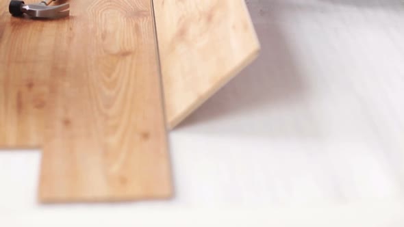 Close Up Of Man Installing Wood Flooring 5