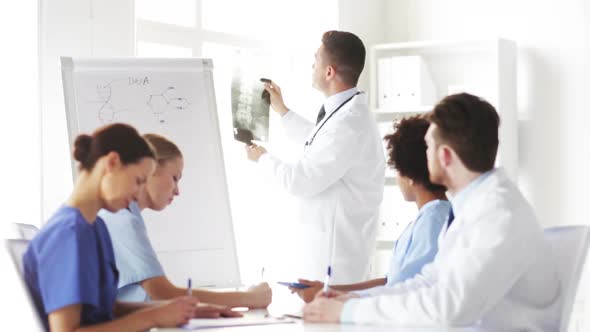 Group Of Doctors Looking At X-Ray In  Hospital alt