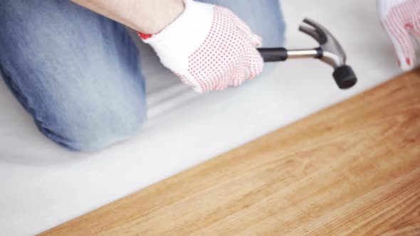 Close Up Of Man Installing Wood Flooring 9