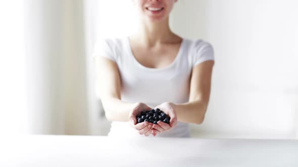 Close Up Of Young Woman Showing Blueberries 3