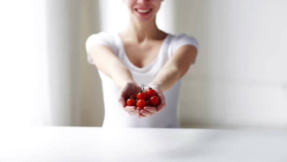 Close Up Of Young Woman Showing Cherry Tomatoes 1