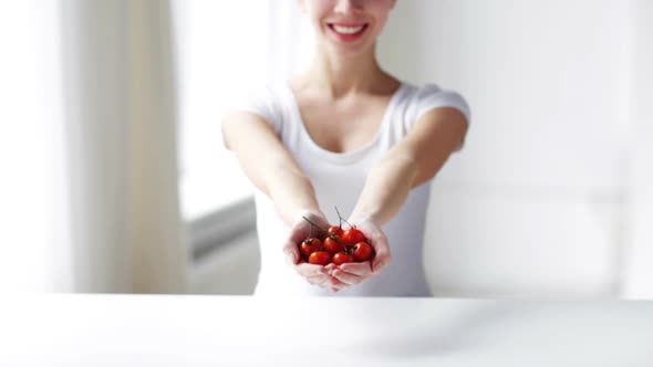 Close Up Of Young Woman Showing Cherry Tomatoes 2