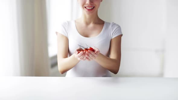 Close Up Of Young Woman Showing Cherry Tomatoes 4 alt