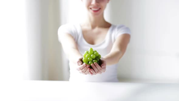 Close Up Of Young Woman Showing Green Grape Bunch 2