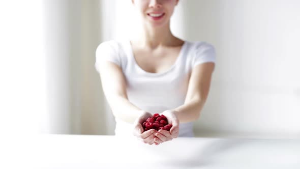 Close Up Of Young Woman Showing Raspberries 1