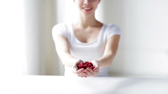 Close Up Of Young Woman Showing Raspberries 2