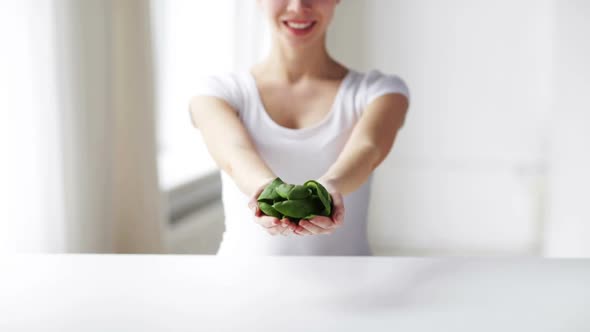 Close Up Of Young Woman Showing Spinach 4