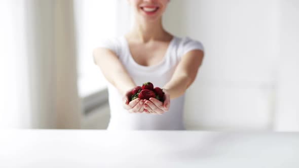 Close Up Of Young Woman Showing Strawberries 1