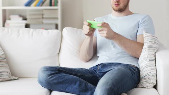 Close Up Of Man Playing Game On Smartphone At Home 1