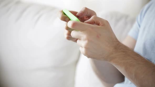 Close Up Of Man Playing Game On Smartphone At Home 3