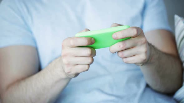Close Up Of Man Playing Game On Smartphone At Home 4