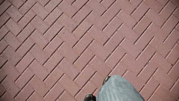 Man Walking On Pavement