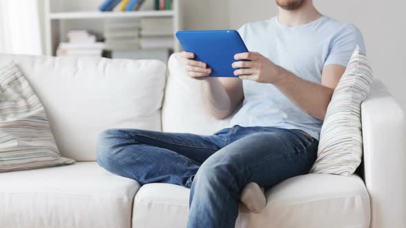 Close Up Of Man Playing Game On Tablet Pc At Home 1