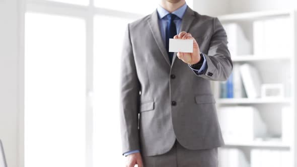 Close Up Of Businessman Showing White Blank Card 2