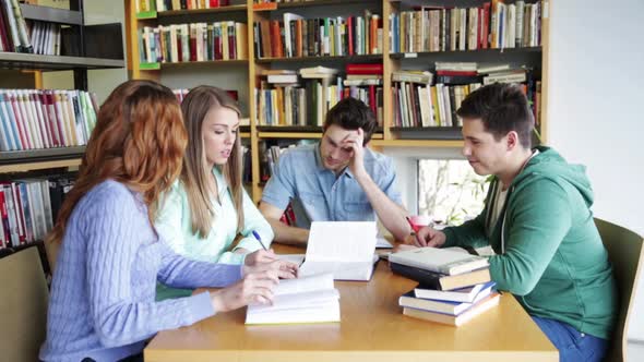 Students With Books Preparing To Exam In Library 11