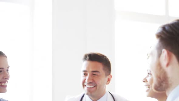 Group Of Happy Doctors Making High Five At Clinic 2 alt