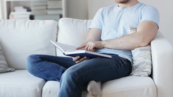 Close Up Of Man Reading Book At Home 1