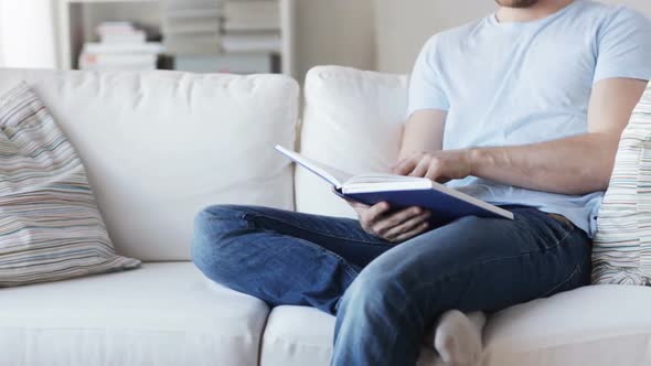 Close Up Of Man Reading Book At Home 2