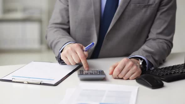 Close Up Of Businessman With Papers And Calculator 1