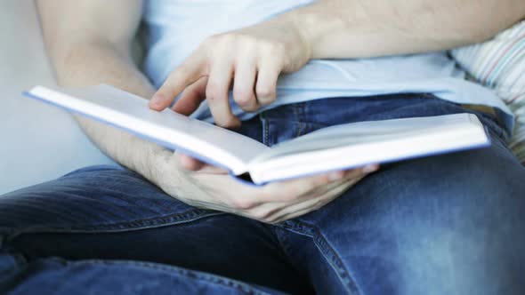 Close Up Of Man Reading Book At Home 4