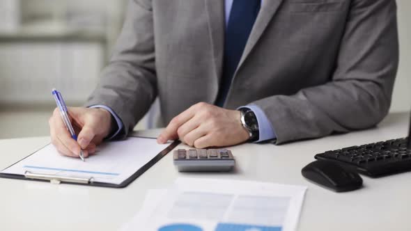 Close Up Of Businessman With Papers And Calculator 2