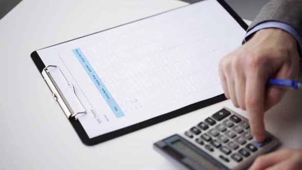 Close Up Of Businessman With Papers And Calculator 3 alt