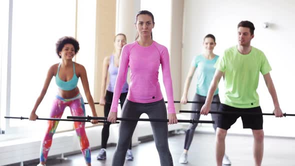 Group Of People Exercising With Bars In Gym 4 alt