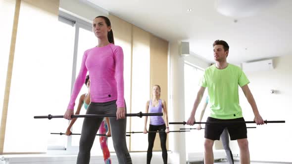 Group Of People Exercising With Bars In Gym 9 alt