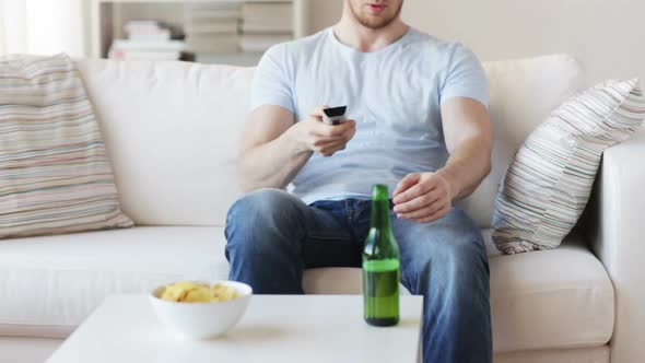Close Up Of Man With Beer And Remote At Home 1 alt