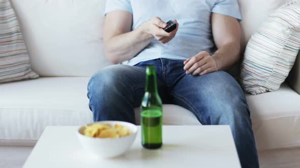 Close Up Of Man With Beer And Remote At Home 4