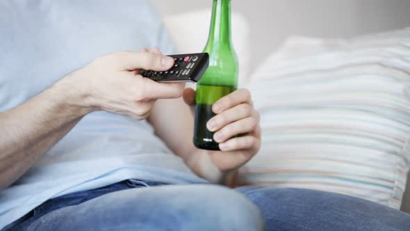 Close Up Of Man With Beer And Remote At Home 6