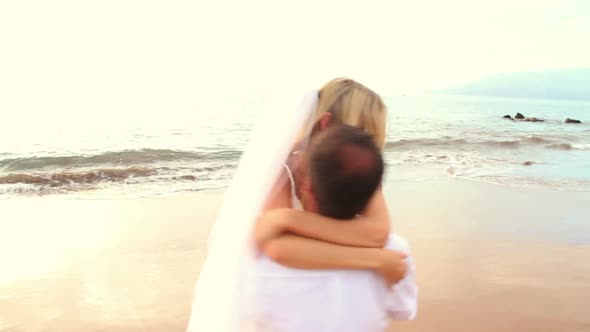 Newly Married Couple On Tropical Beach At Sunset 12