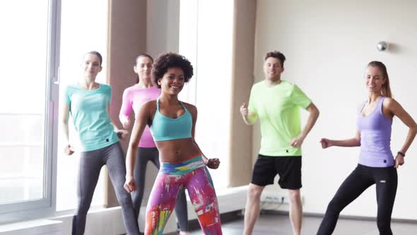 Group Of Smiling People Dancing In Gym Or Studio 6 alt