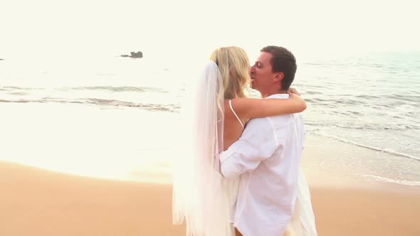 Newly Married Couple On Tropical Beach At Sunset 4