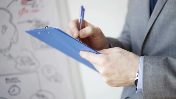 Close Up Of Man With Business Scheme And Clipboard 3