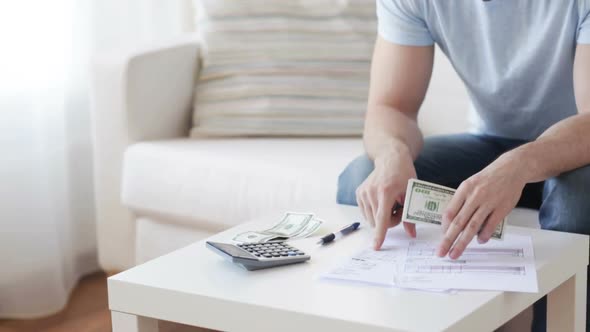 Close Up Of Man With Calculator Counting Money 2