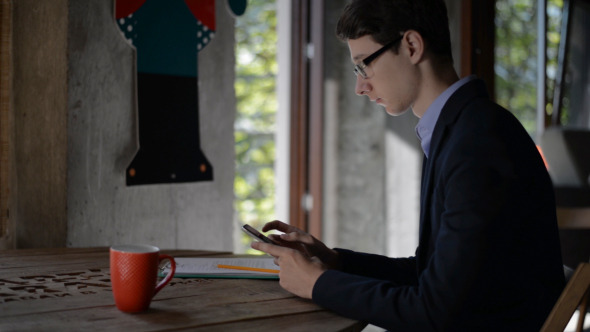 Young Man Browsing Smartphone